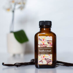 Custom Vanilla Labels - Watercolor Style - Shown at 1.25X2.5 inches on a flat apothecary bottle. Features watercolor vanilla beans and flowers.