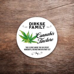 Customizable cannabis label featuring cannabis leaf graphics on a white background with black text. This photo shows a round label. All text on the label is customizable.