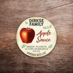 Customizable apple label featuring a red apple illustration on a vintage paper background. This photo shows a round label. All text on the label is customizable.